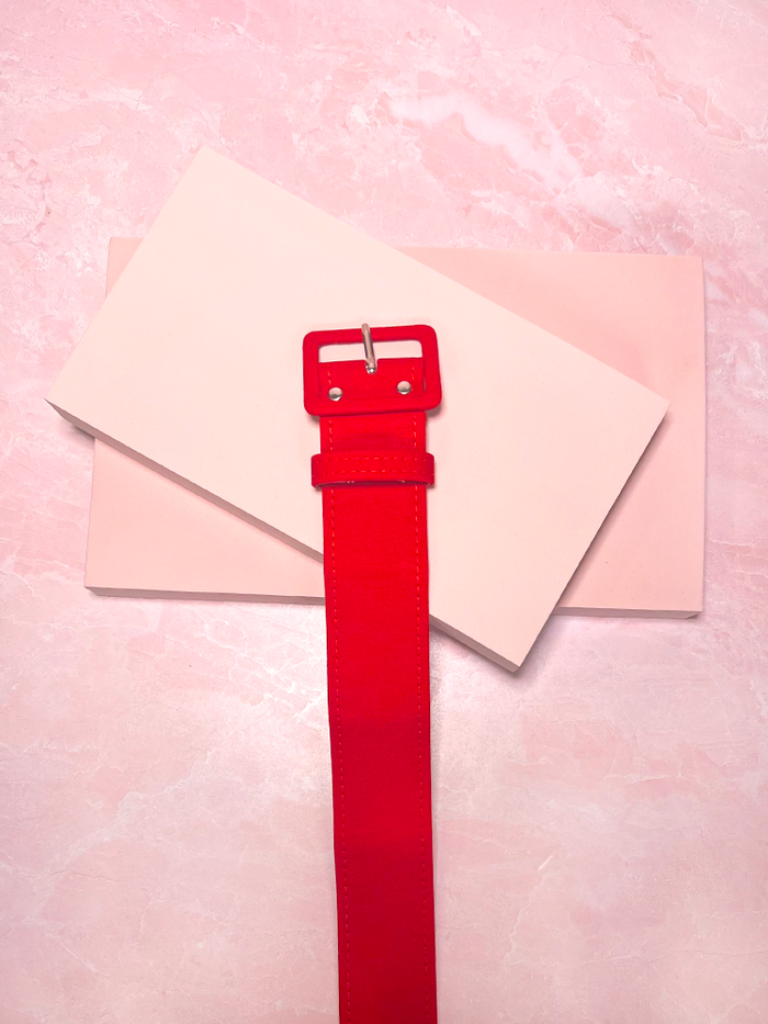 The 1" Belt in Red Bengaline brings a pop of vintage-inspired flair to your wardrobe, with its vibrant color and sleek design. Perfect for adding definition and a bold touch to any outfit.