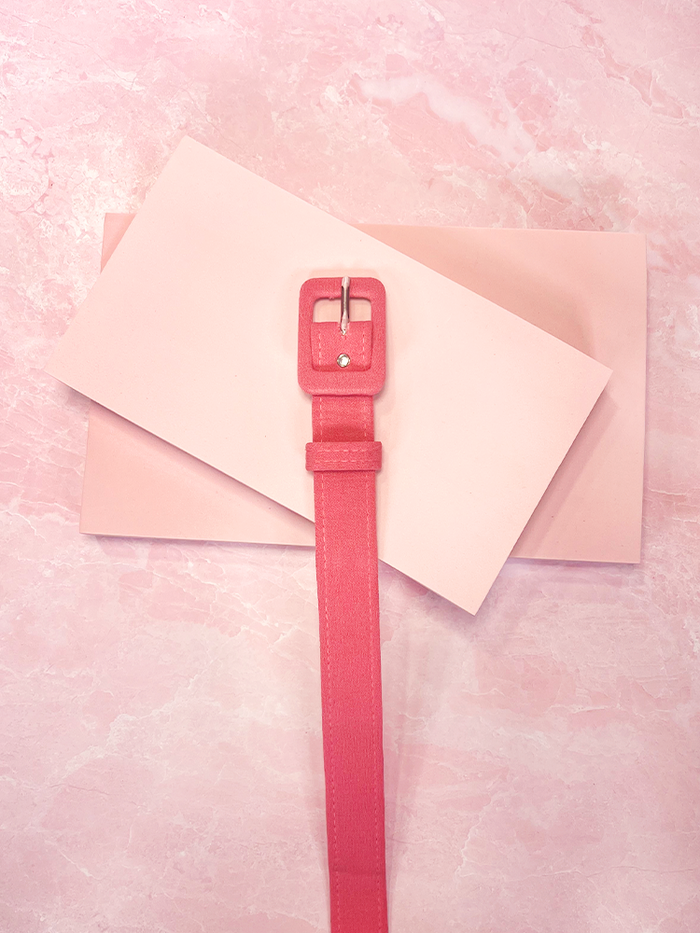 Elevate your style with this pink crepe belt, a subtle yet elegant accessory that brings a hint of retro sophistication to any outfit.