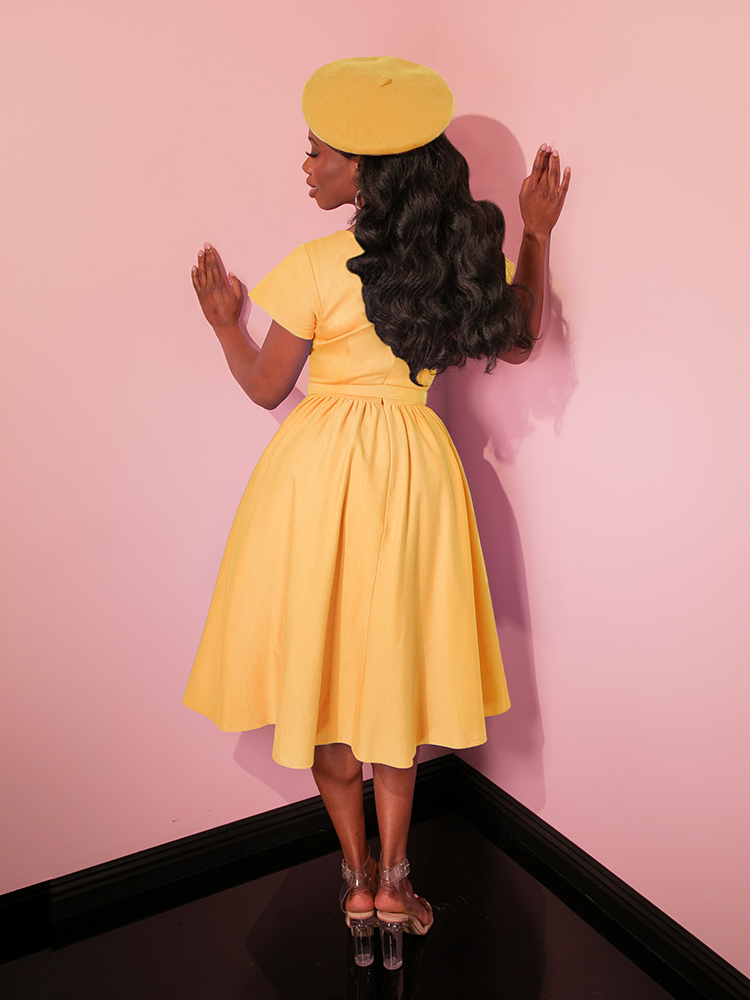 Brighten up your wardrobe with the Avon Swing Dress in Pastel Yellow, a vintage-inspired beauty designed for effortless grace. With its flattering silhouette and retro charm, this dress is a must-have for lovers of classic fashion.