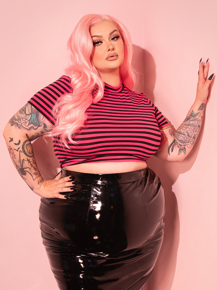 With its eye-catching pink and black stripes, the Bad Girl Crop Top delivers a retro-inspired, edgy look that’s both playful and chic.