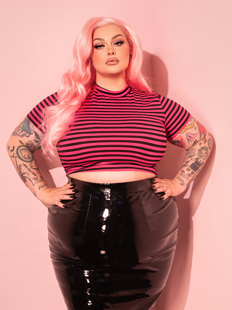 Embrace your inner rebel with the Bad Girl Crop Top, featuring playful pink and black stripes and a retro cropped design that’s perfect for making a statement.