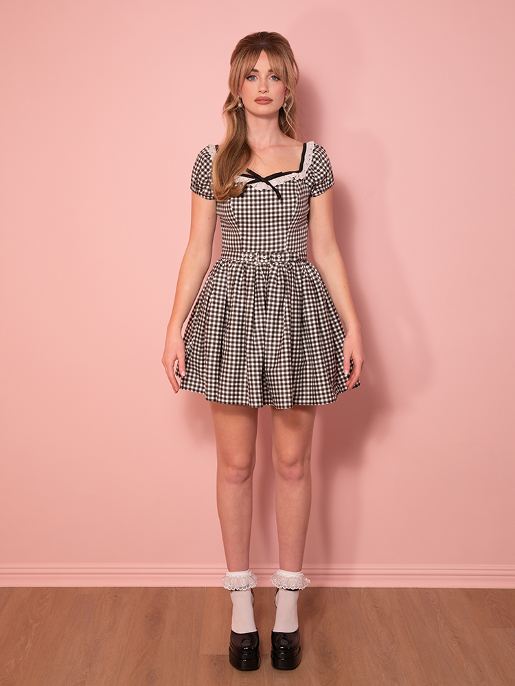 Perfect for picnics or nights out, this gingham mini dress combines vintage allure with a shorter hemline for a fresh take on 1950s fashion.
