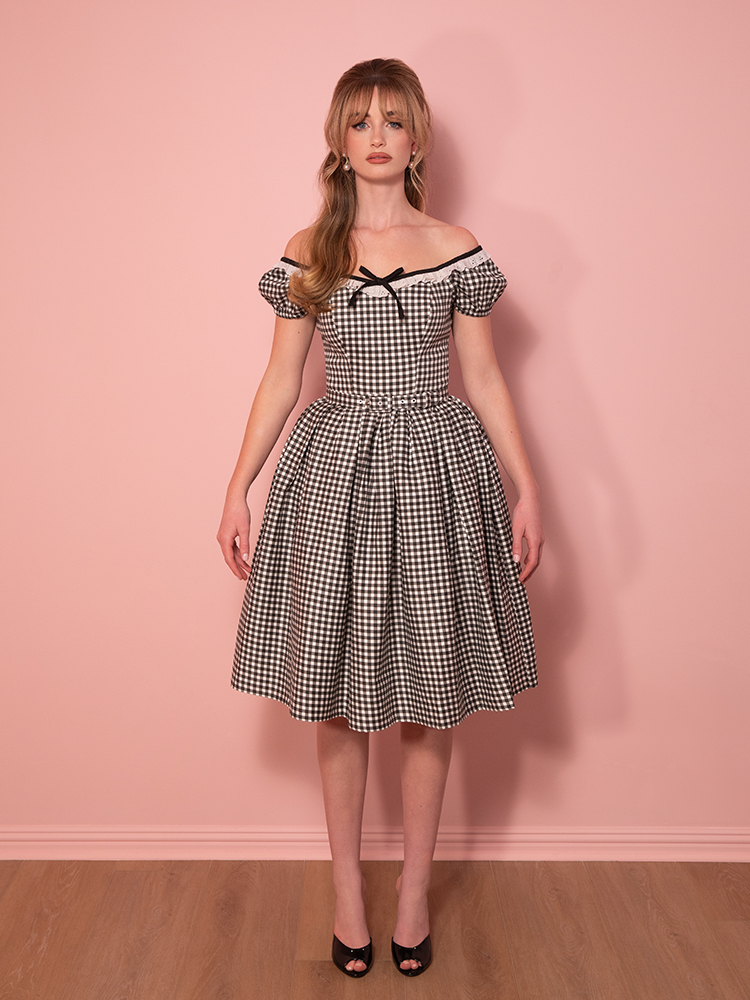 A staple for vintage lovers, this gingham swing dress pairs an off-the-shoulder neckline with a flattering, flowing skirt for a classic yet playful look.
