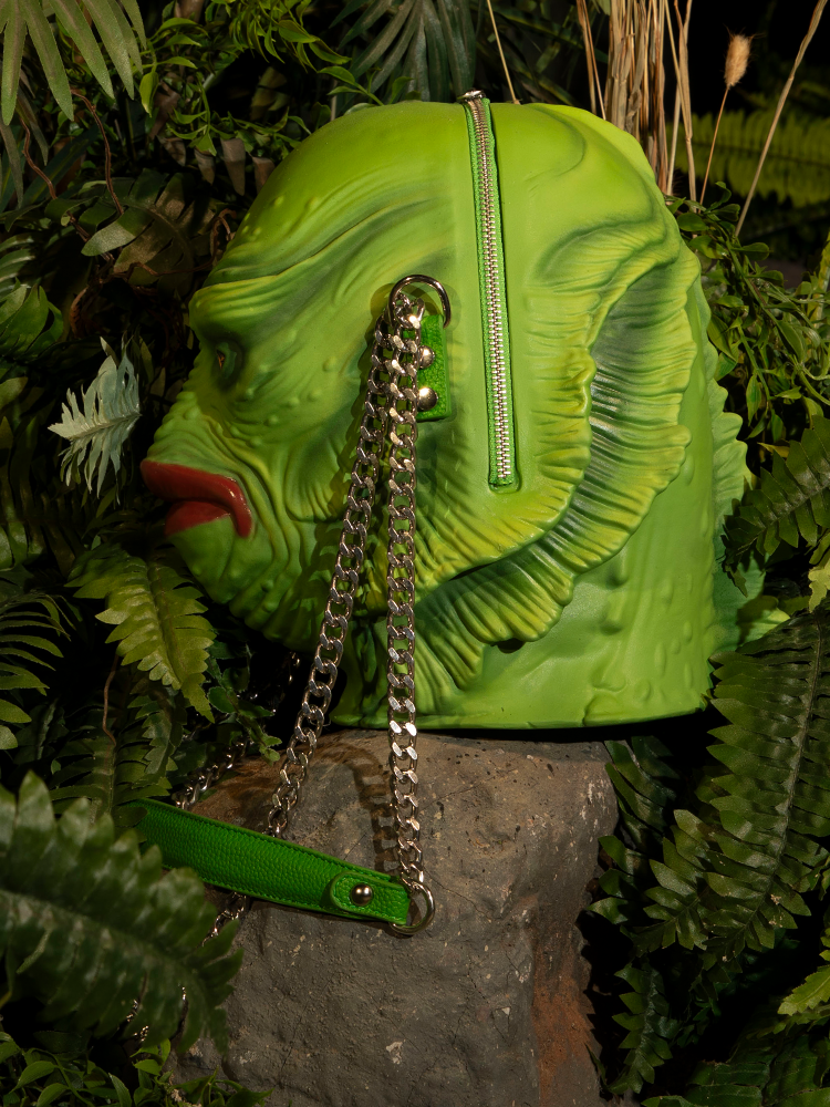 Elevate your accessory game with the Creature from the Black Lagoon Monster Bag, blending classic horror elements with modern fashion.