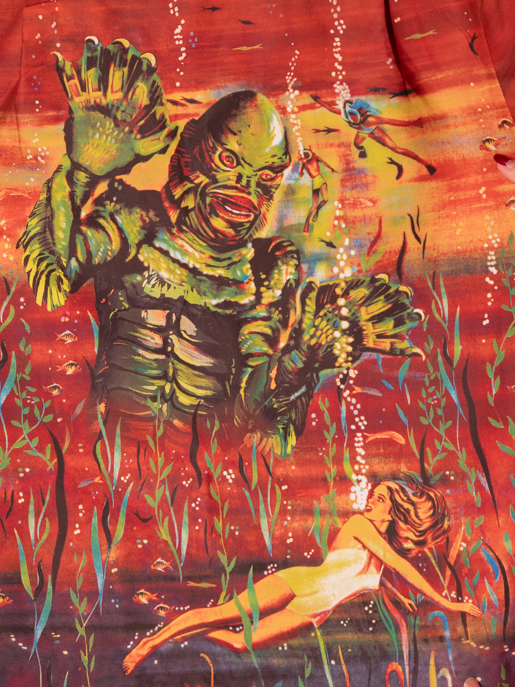 Capture vintage horror vibes with our rust button-up featuring the Creature from the Black Lagoon movie poster, a unique piece for any fan of classic Hollywood monsters.