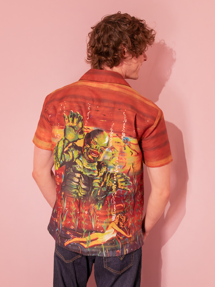 Make a statement with our rust-colored unisex button-up, adorned with the Creature from the Black Lagoon vintage movie poster for a retro-inspired ensemble.