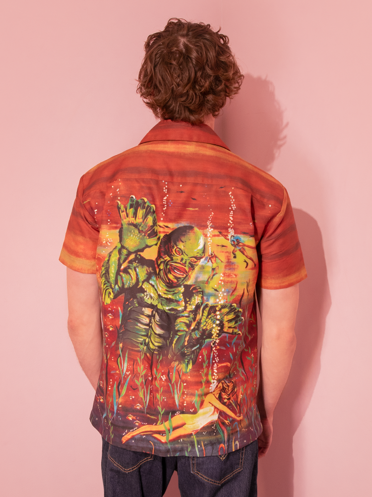 Channel the allure of classic horror films with our rust button-up, showcasing the Creature from the Black Lagoon for a timeless and stylish look.