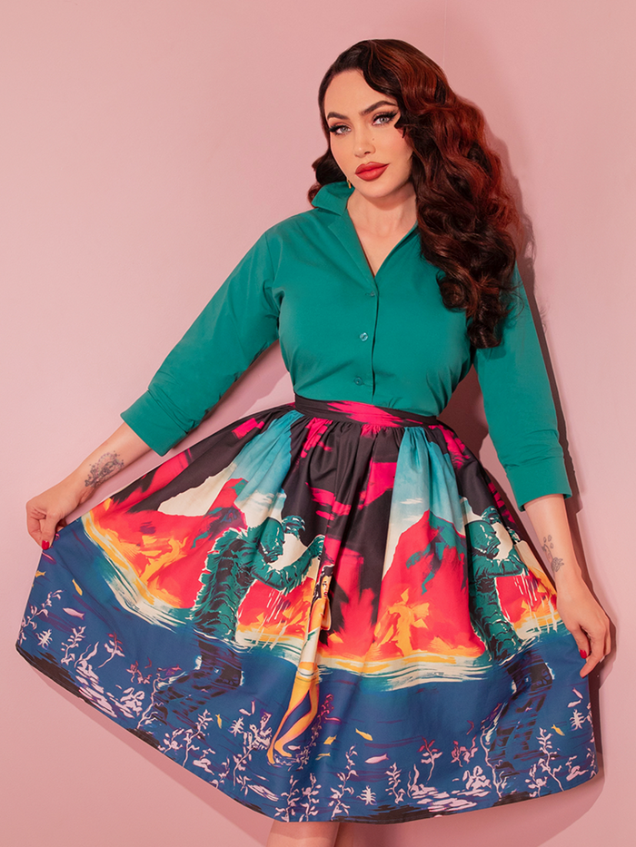 Embrace retro horror style with the Universal Monsters: CREATURE FROM THE BLACK LAGOON™ vintage movie poster skirt in teal, perfect for a unique and stylish look.