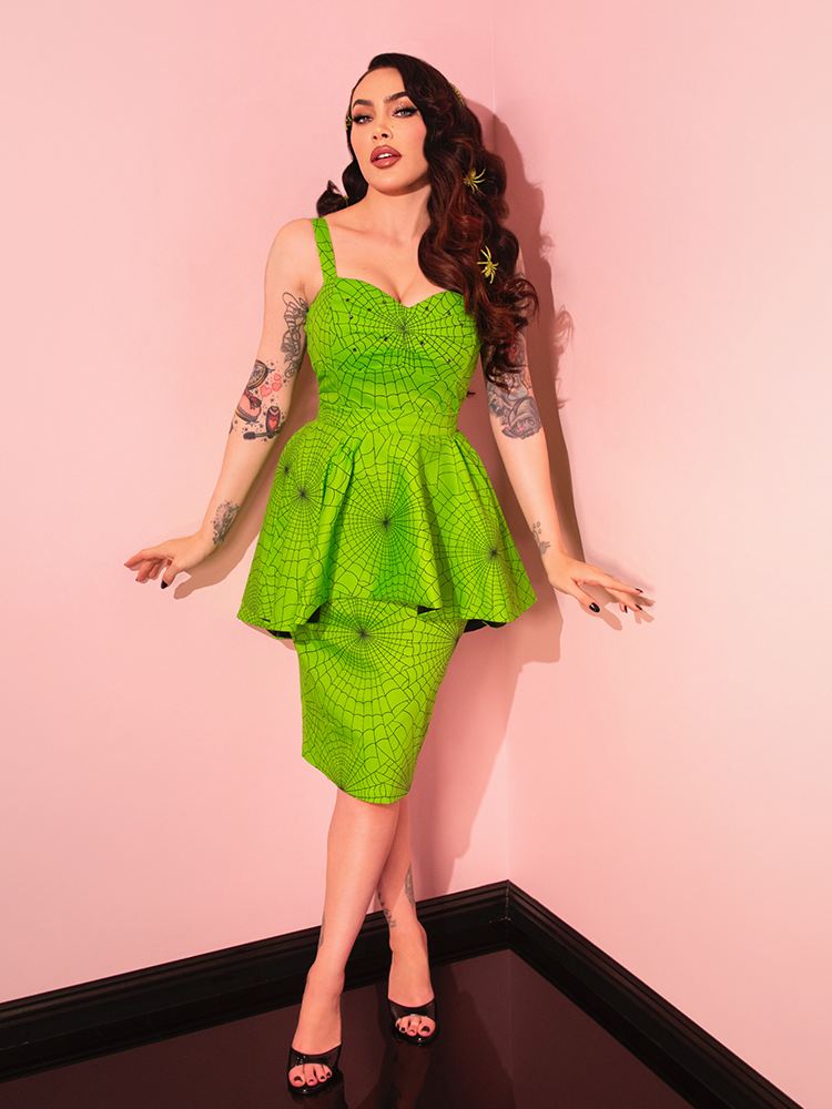 The Glamour Girl Dress in Slime is a retro-inspired masterpiece, featuring a sleek silhouette and a vivid color that's perfect for making an entrance.