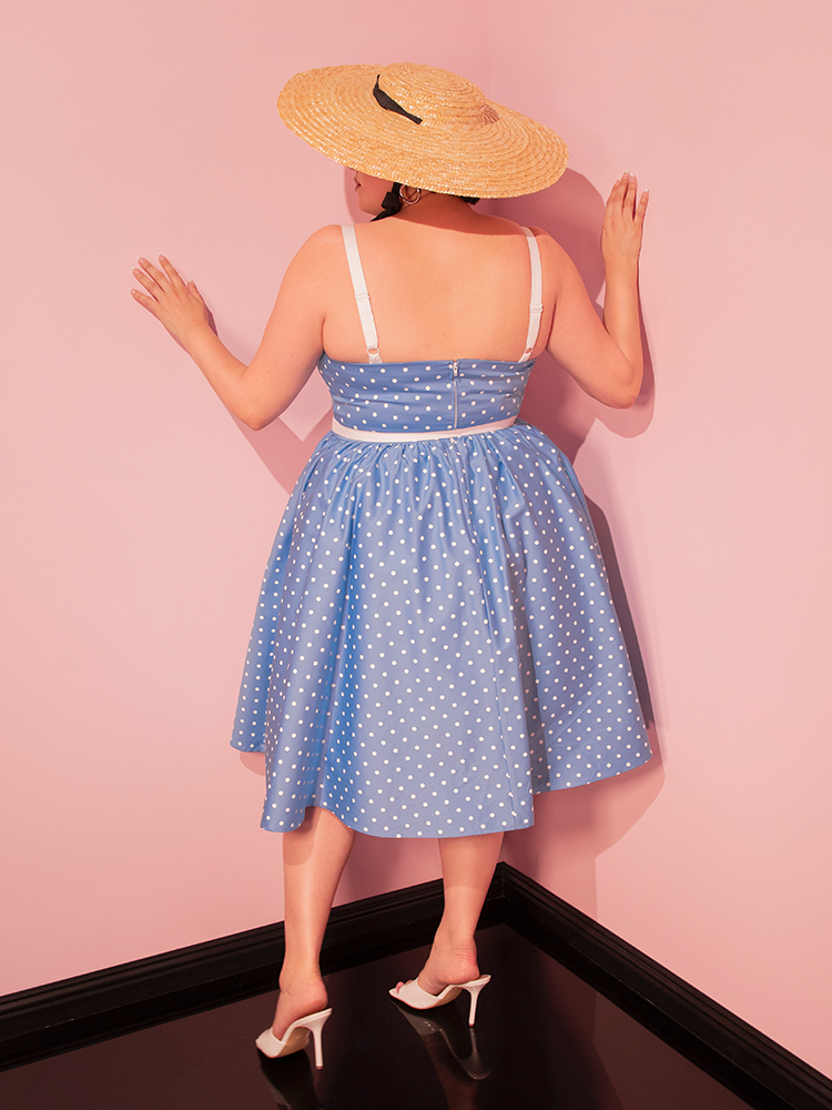 Embrace the beauty of yesteryear with the Ingenue Swing Dress in Light Blue with White Polka Dots, a retro dress that celebrates classic Hollywood charm.