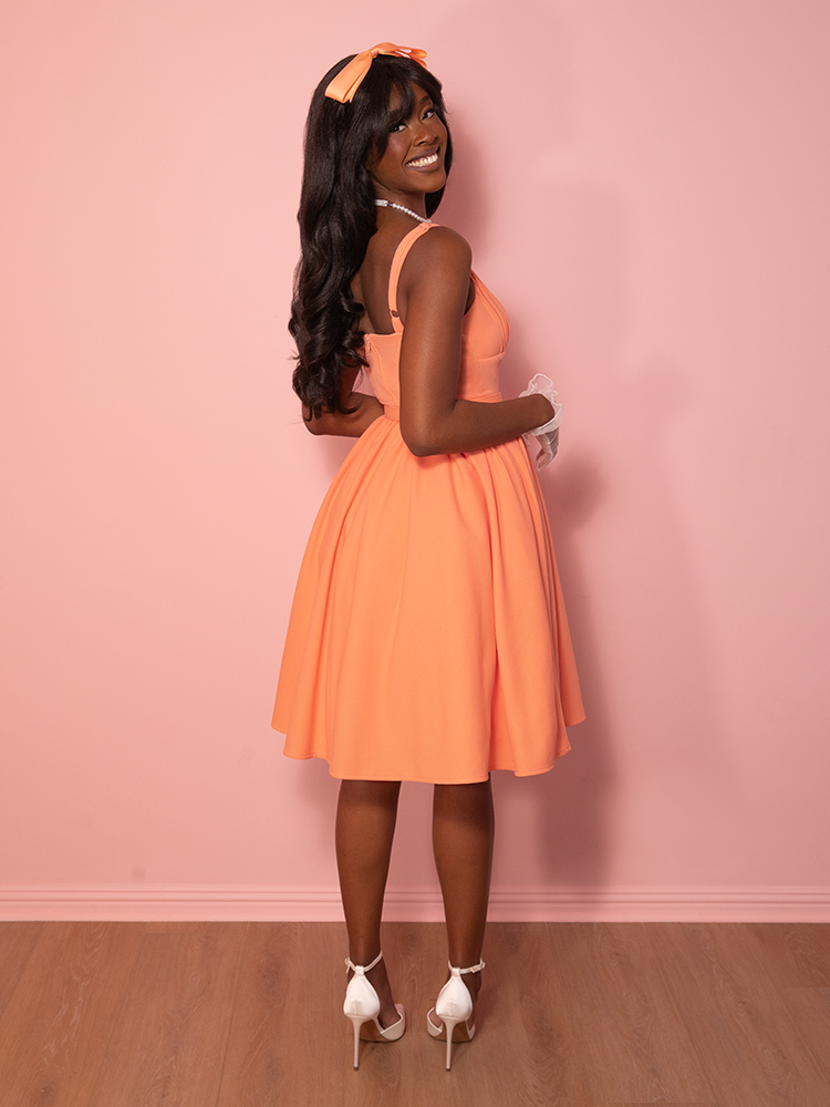 For lovers of vintage fashion, this creamsicle dress is a must-have, offering a graceful silhouette with a nostalgic nod to classic 1950s style.
