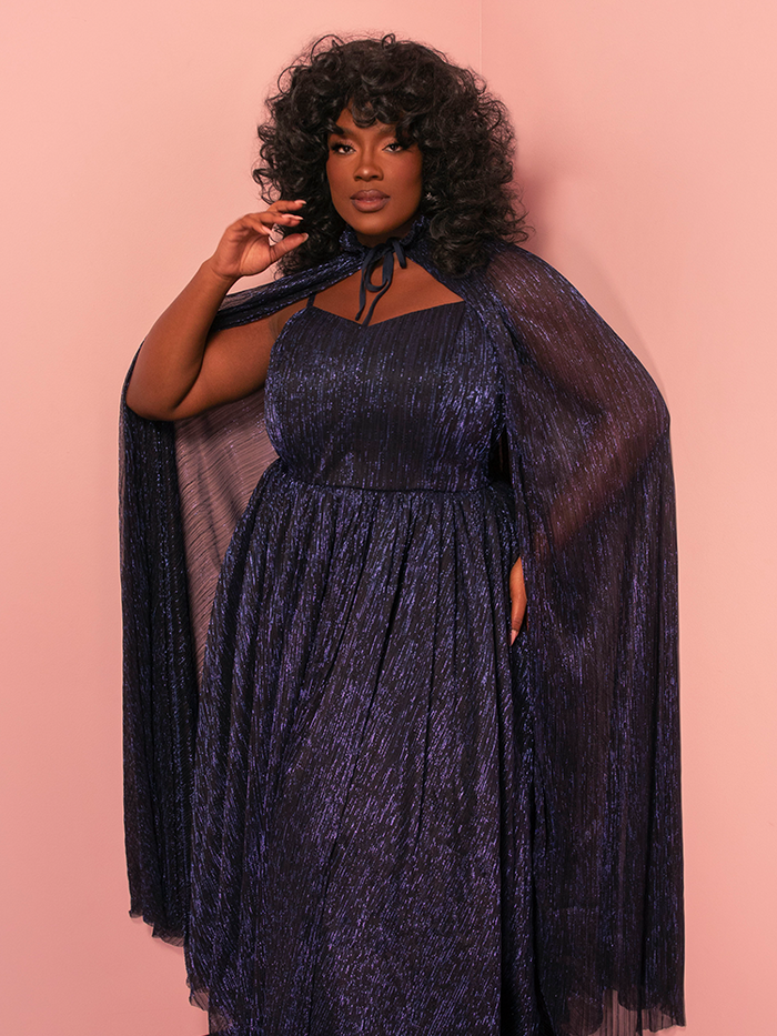 Step into fantasy with this vintage-inspired midnight blue gown and matching cape, channeling regal Hollywood glamour.