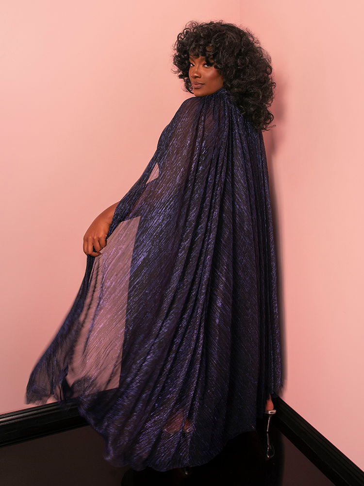 Envelop yourself in the mystique of a vintage-style gown and cape, fit for a midnight fairytale.