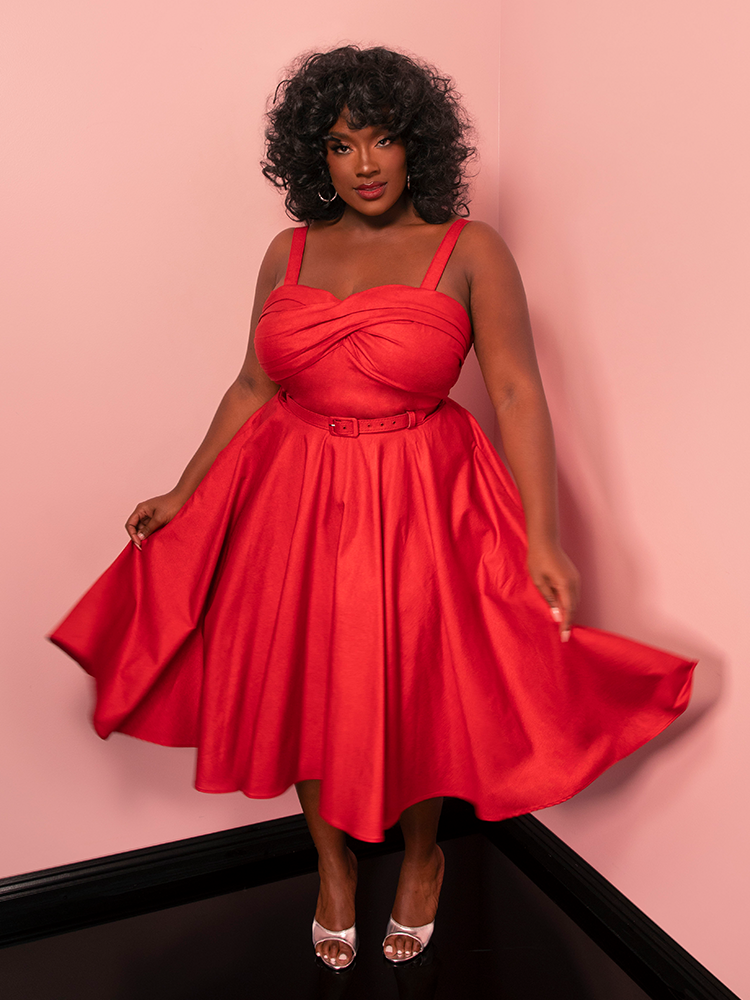 Shine like a star in the Jawbreaker Swing Dress, featuring a vibrant red sparkle laminate that channels retro sophistication with a modern twist.