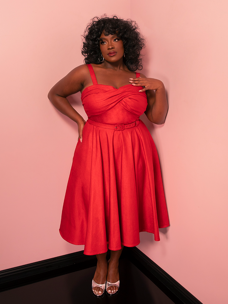 Make every moment sparkle in the Jawbreaker Swing Dress, a red laminate vintage-inspired stunner that promises timeless elegance and head-turning style.