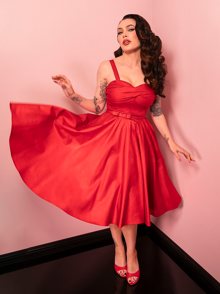 Evoke timeless glamour with the Jawbreaker Swing Dress in red sparkle laminate, a radiant design ideal for standout holiday looks or special events.