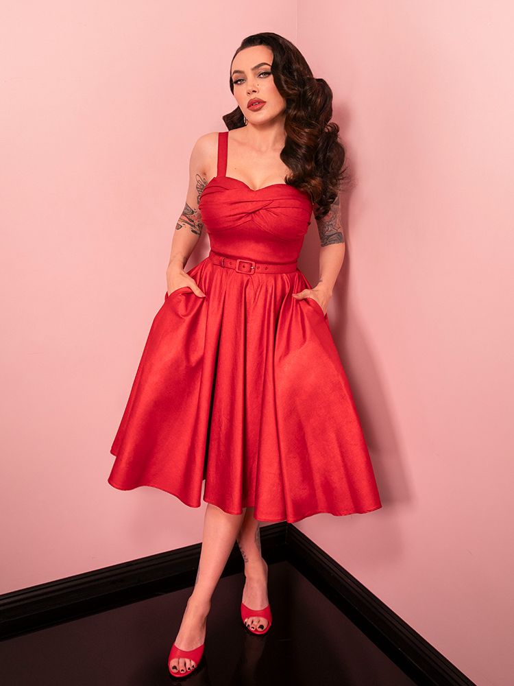 This red sparkle laminate swing dress is a vintage-inspired masterpiece, bringing classic Hollywood drama and sparkle to your wardrobe.