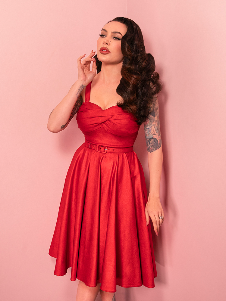 Dazzle in the Jawbreaker Swing Dress, a vintage-inspired piece with a red sparkle laminate finish that’s perfect for dancing the night away.