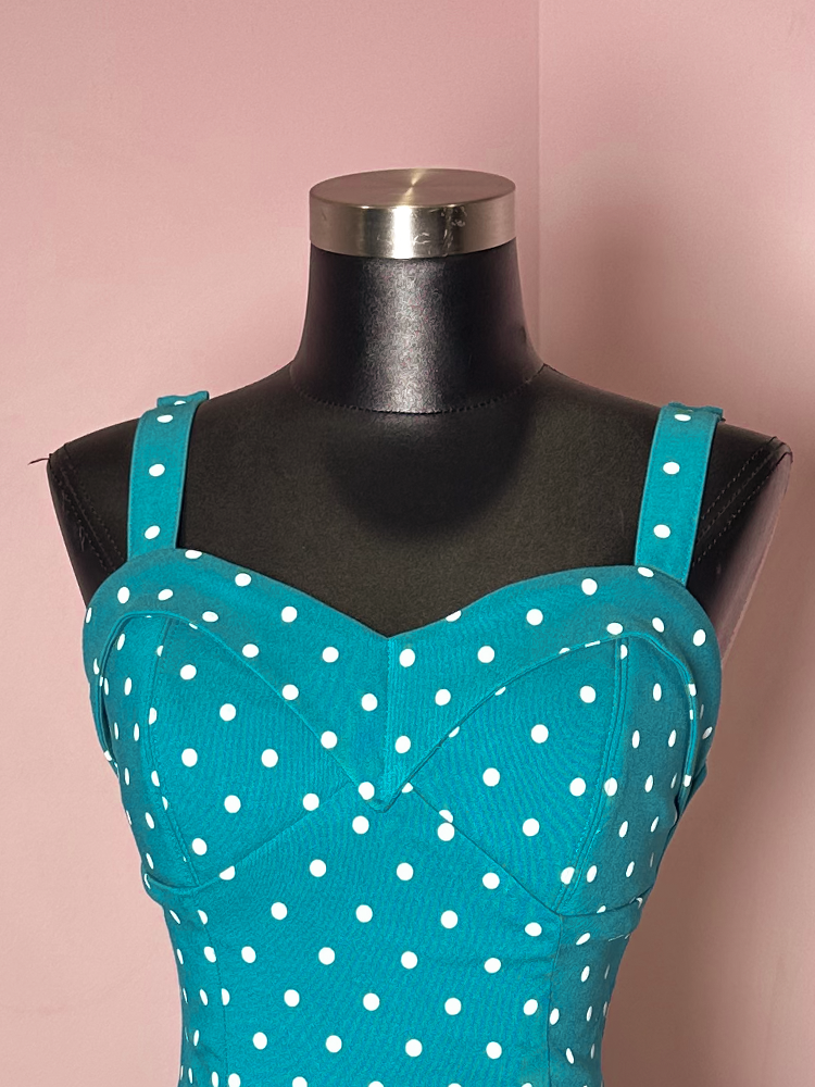 Turn heads with the Maneater Wiggle Dress in teal blue polka dot, a classic Hollywood-inspired piece that brings retro chic to any occasion.