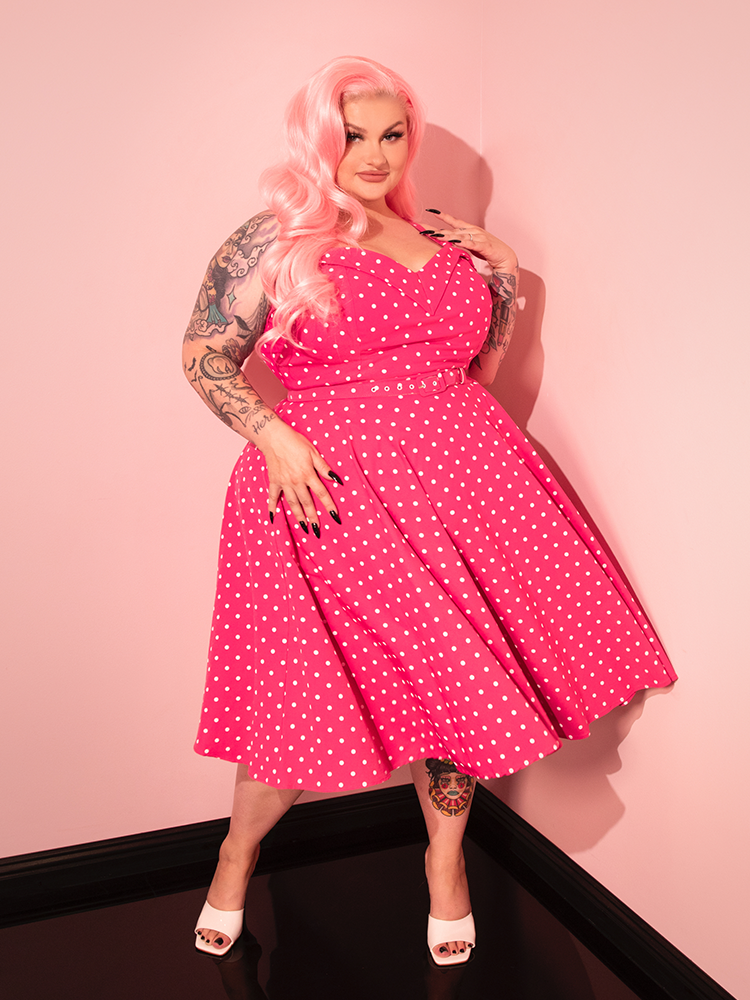 Perfect for pin-up enthusiasts, the Maneater Pink Polka Dot Swing Dress captures the essence of '50s fashion with a modern twist.