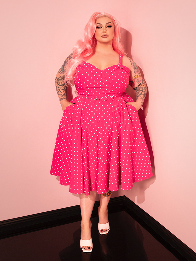 The Maneater Pink Polka Dot Swing Dress combines a classic swing shape with vibrant pink polka dots, giving a nod to vintage-inspired elegance.