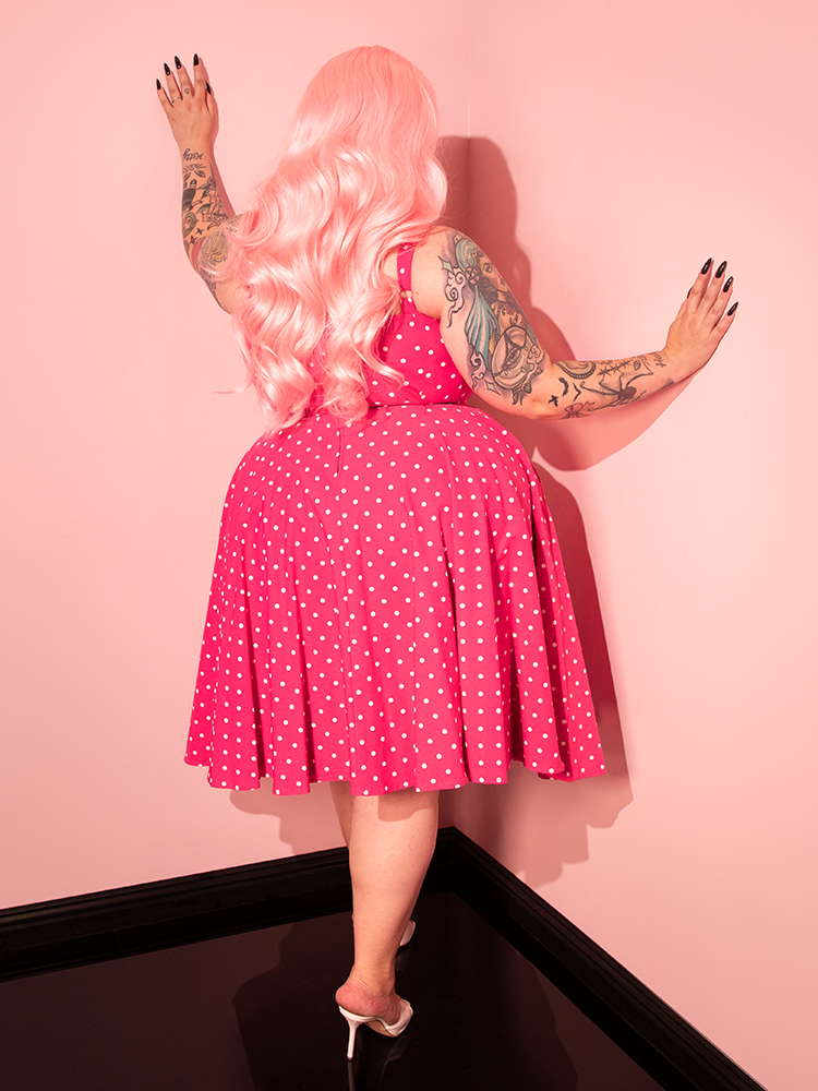 Add some retro charm to your day with the Maneater Pink Polka Dot Swing Dress, featuring a flattering silhouette and a fun polka dot pattern.