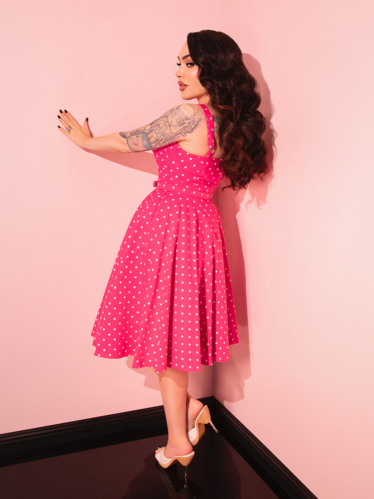 The Maneater Pink Polka Dot Swing Dress is the perfect retro dress for those who love playful prints and classic cuts, ideal for any occasion.