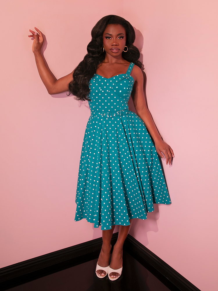 Embrace vintage style with the Maneater Swing Dress, featuring a playful teal blue polka dot pattern perfect for channeling retro glamour.