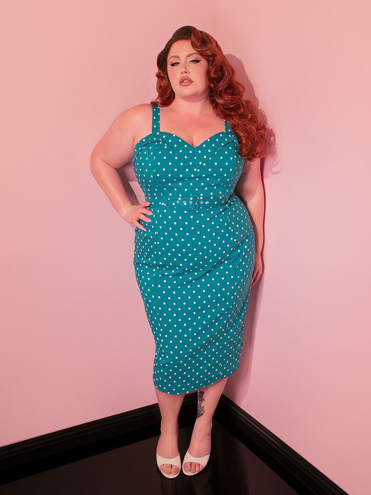 Capture the essence of 1950s fashion with the Maneater Wiggle Dress, a retro-inspired dress in teal blue polka dot that exudes elegance and charm.