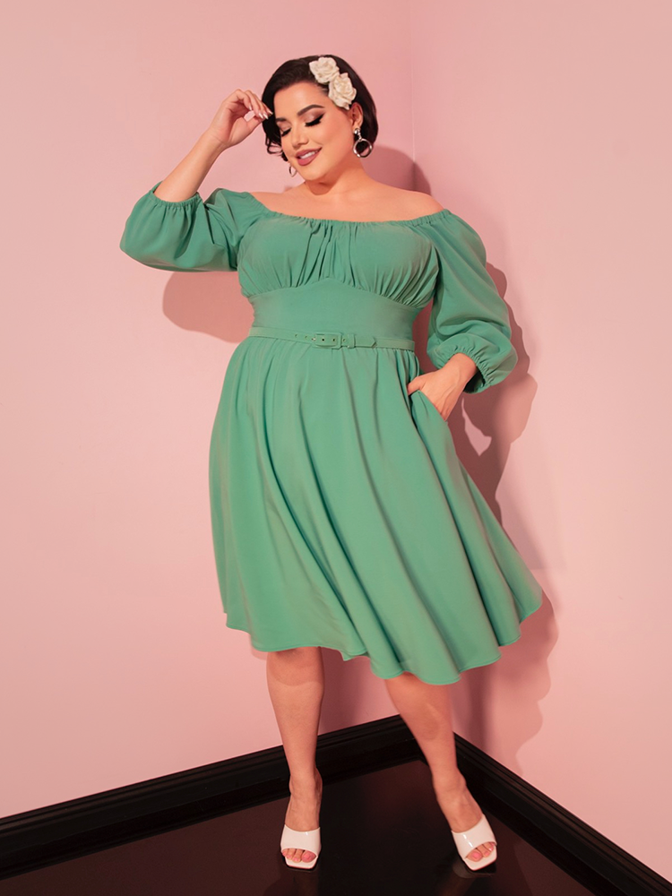 Elevate your vacation style with this moss green dress, a perfect piece for a chic and timeless retro-inspired ensemble.