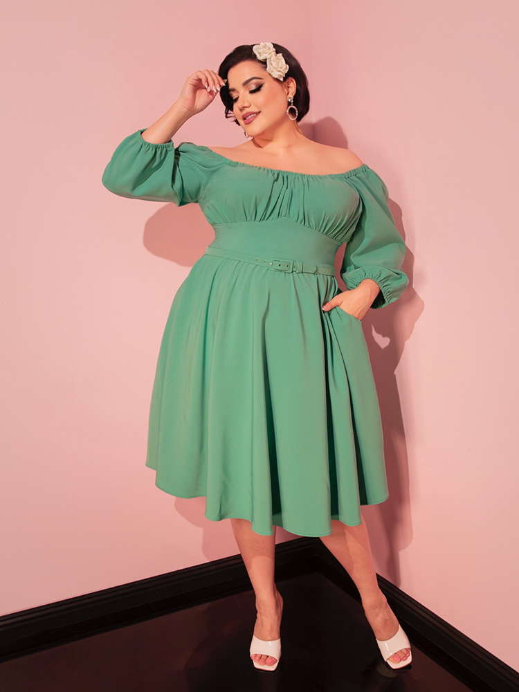 Add a touch of sophistication to your getaway with this moss green vacation dress, designed for a retro-inspired look.