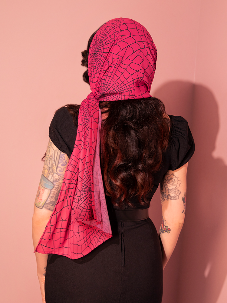 Elevate your vintage-inspired ensemble with this hot pink spider web print chiffon scarf, capturing the fun and flirty spirit of 1950s fashion. A chic accessory for those who love bold, retro prints.