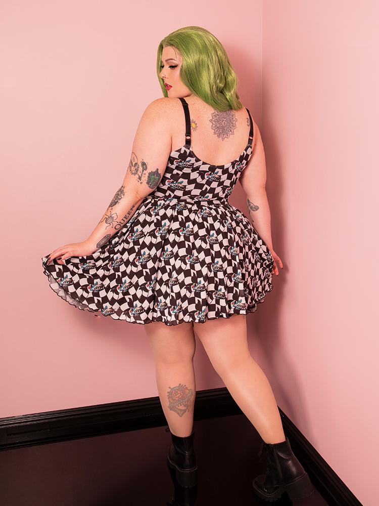 The Beetlejuice Sandworm Swing Dress, with its standout print and chic bolero, offers a playful take on classic Hollywood style with a bold vintage twist.