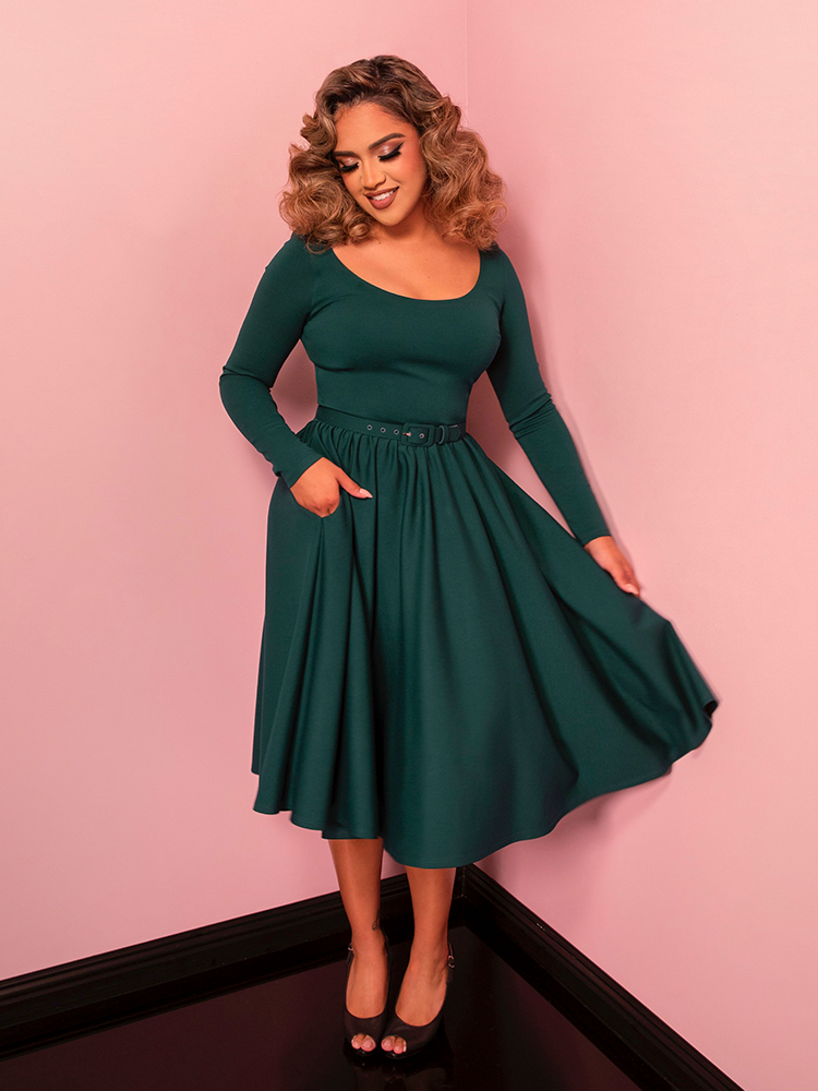 Channel the glamour of Old Hollywood in the Troublemaker Swing Dress, a vintage-inspired piece in lush spruce green. Its swing silhouette adds a playful yet elegant touch to your wardrobe.