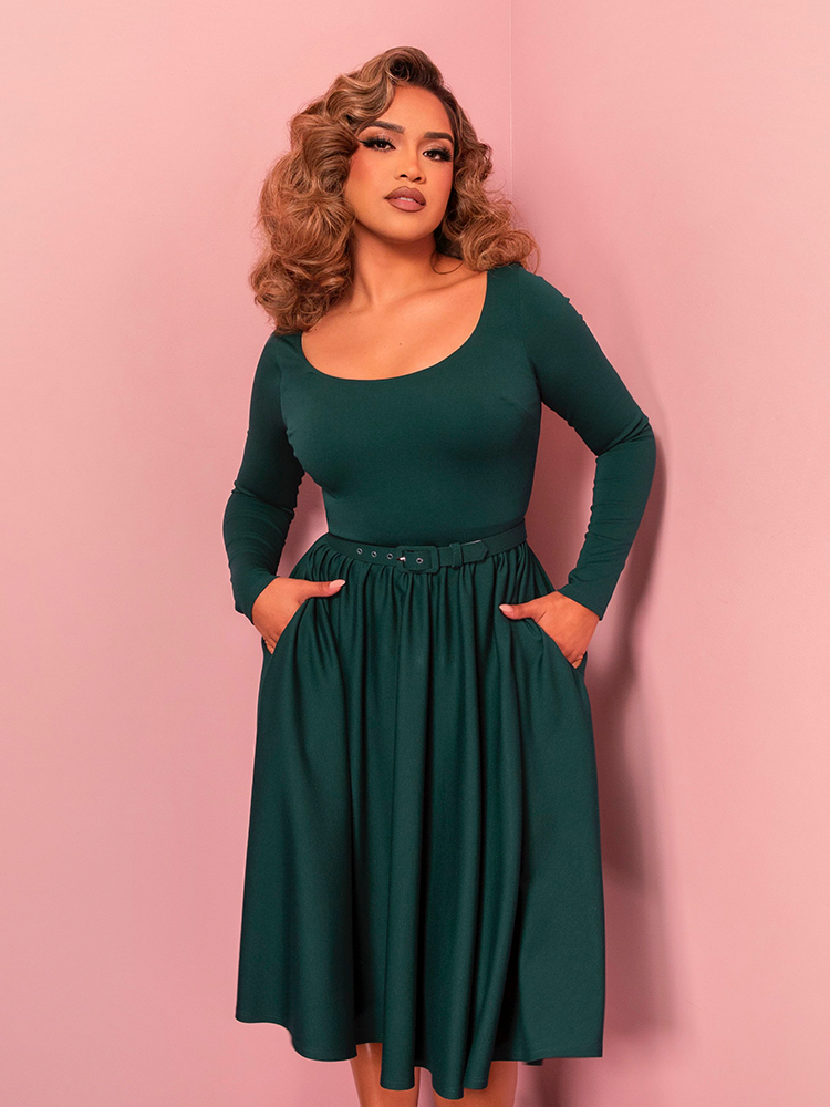 Dance the night away in the Troublemaker Swing Dress, a spruce green vintage-inspired dress with a full skirt and timeless charm. Perfect for embodying classic Hollywood elegance at any event.