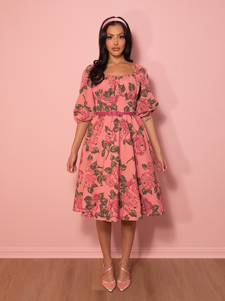 Flirty, feminine, and full of charm, this vintage vacation dress in blush pink features delicate floral prints and a flattering silhouette.
