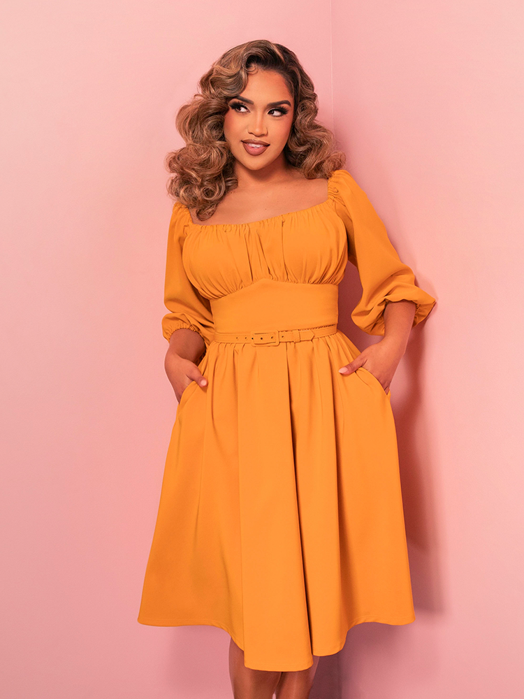 The Vacation Dress in Mustard Gold brings vintage vibes to your wardrobe with its chic simplicity. The mustard gold hue adds a bold yet timeless touch for any vacation look.