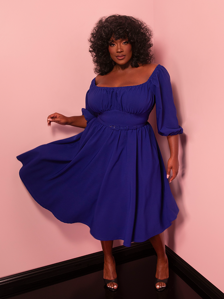 Turn heads on vacation with this royal blue vintage-style dress, designed to capture the glamour of a bygone era. Perfect for pairing with statement earrings and heels.