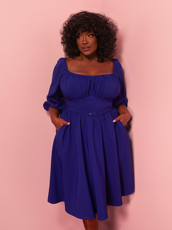 Channel timeless elegance on your getaway with this vacation-ready vintage dress in royal blue. Its flattering silhouette and bold hue evoke classic Hollywood charm.