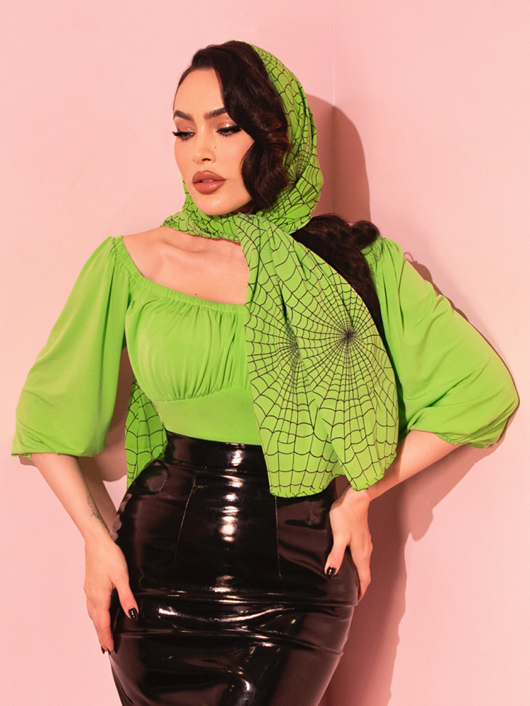 Bring a splash of vintage color to your ensemble with the Vacation Top in Slime, perfect for pairing with high-waisted shorts or skirts.