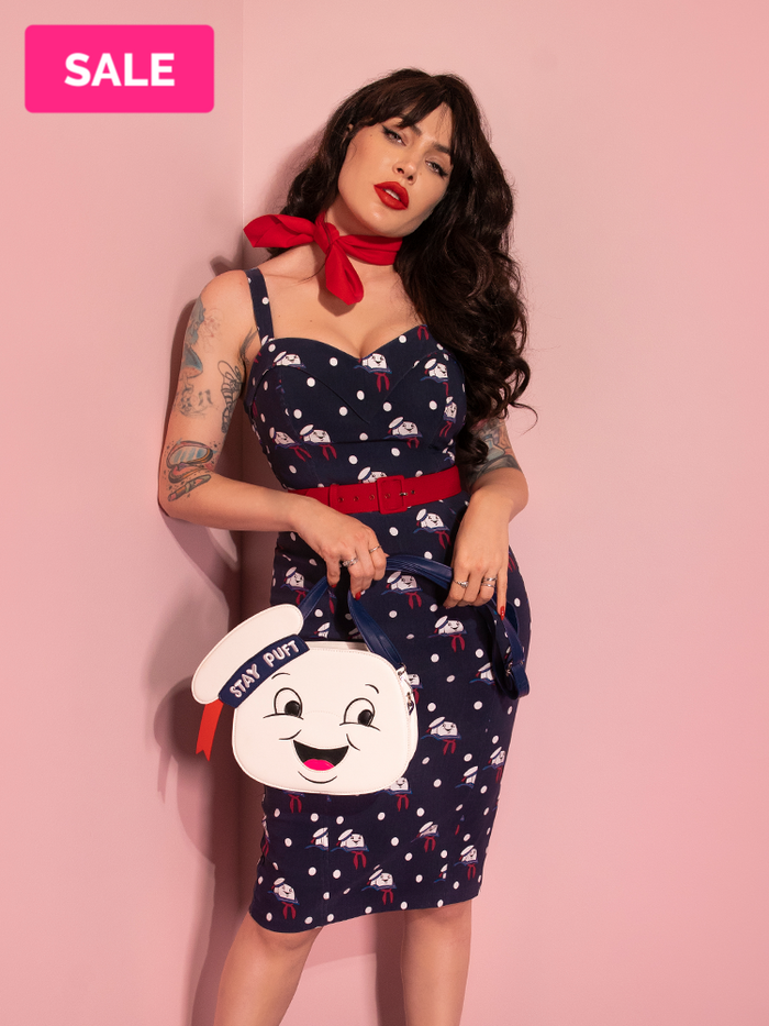 Micheline Pitt posing in a new retro style dress from Vixen Clothing - the GHOSTBUSTERS™ Maneater Wiggle Dress in Stay Puft Novelty Print. 