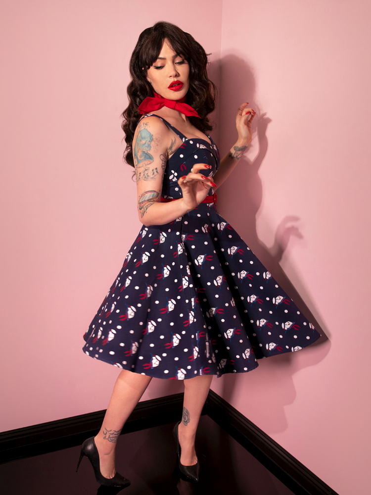 Micheline Pitt twirls while in the GHOSTBUSTERS™ Maneater Swing Dress in Stay Puft Novelty Print from retro dress maker Vixen Clothing.