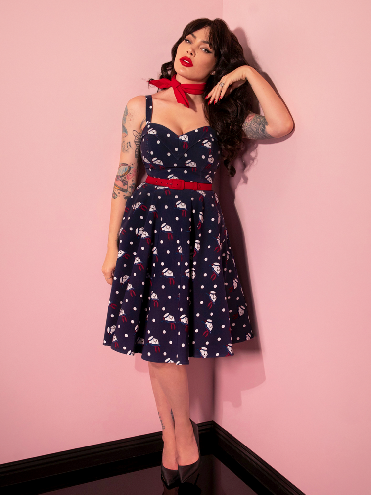 Micheline Pitt posing while in the GHOSTBUSTERS™ Maneater Swing Dress in Stay Puft Novelty Print - the all new retro style dress from Vixen Clothing.