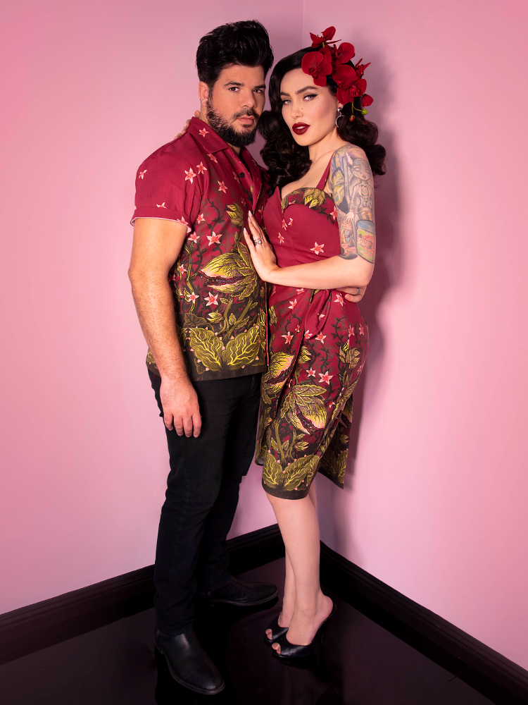 Male model and Micheline Pitt posing together  both wearing retro clothing items featuring the Maneating Monster Print.