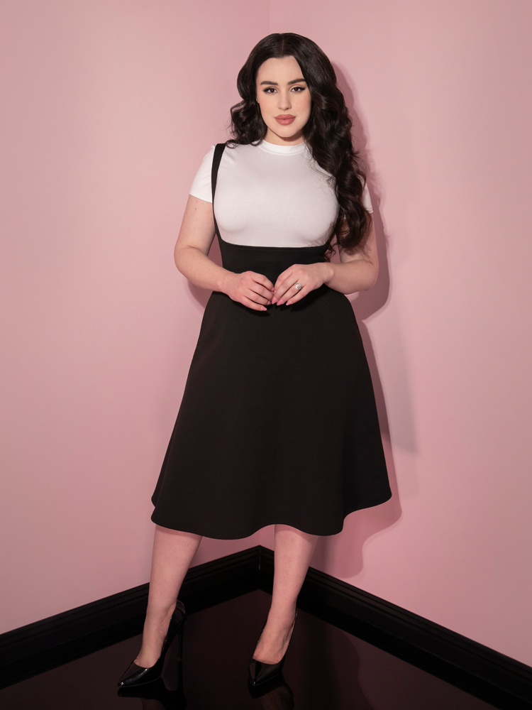 Raven haired model showing off the Cozy Skater Skirt Jumper in Black from Vixen Clothing.